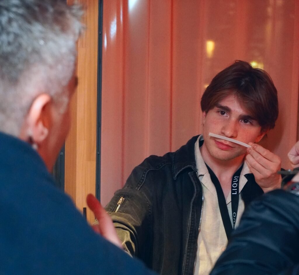 Scent Chronicles Founder Rodrigo Hernandez showing a fragrance to a customer