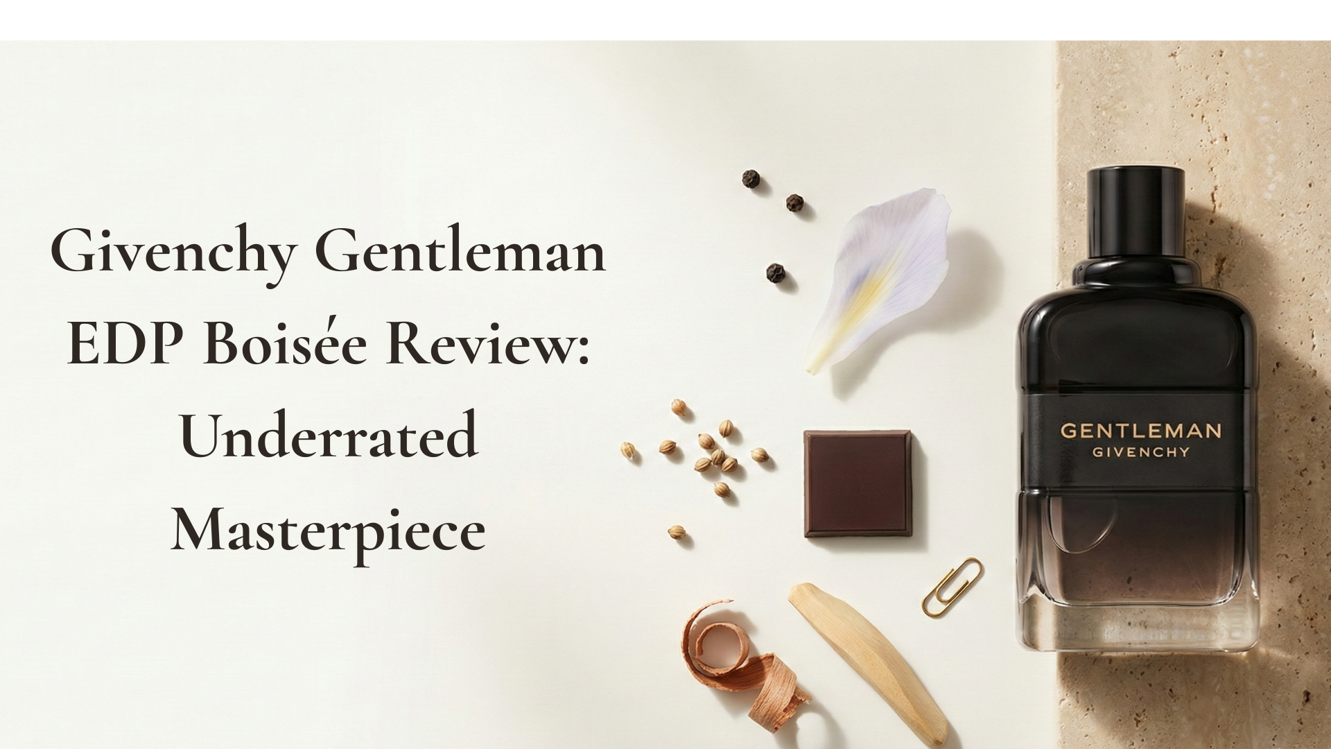 Givenchy Gentleman EDP Boisée bottle in a minimalist editorial scene with iris, cocoa and woods