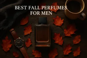 Flat lay of best fall perfumes for men styled with coffee, scarf, and autumn leaves.