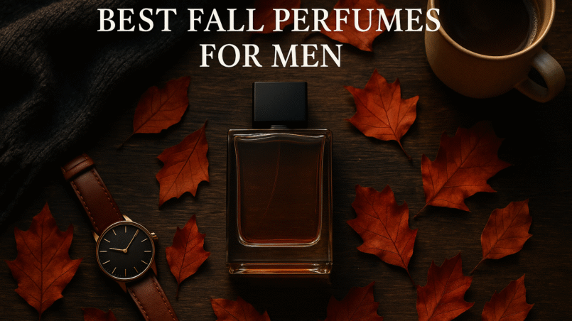 Flat lay of best fall perfumes for men styled with coffee, scarf, and autumn leaves.