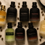 Valentino Perfumes Buying Guide for Men featuring Uomo, Uomo Intense, Uomo Noir Absolu, and Born in Roma fragrances in a luxury flat lay.