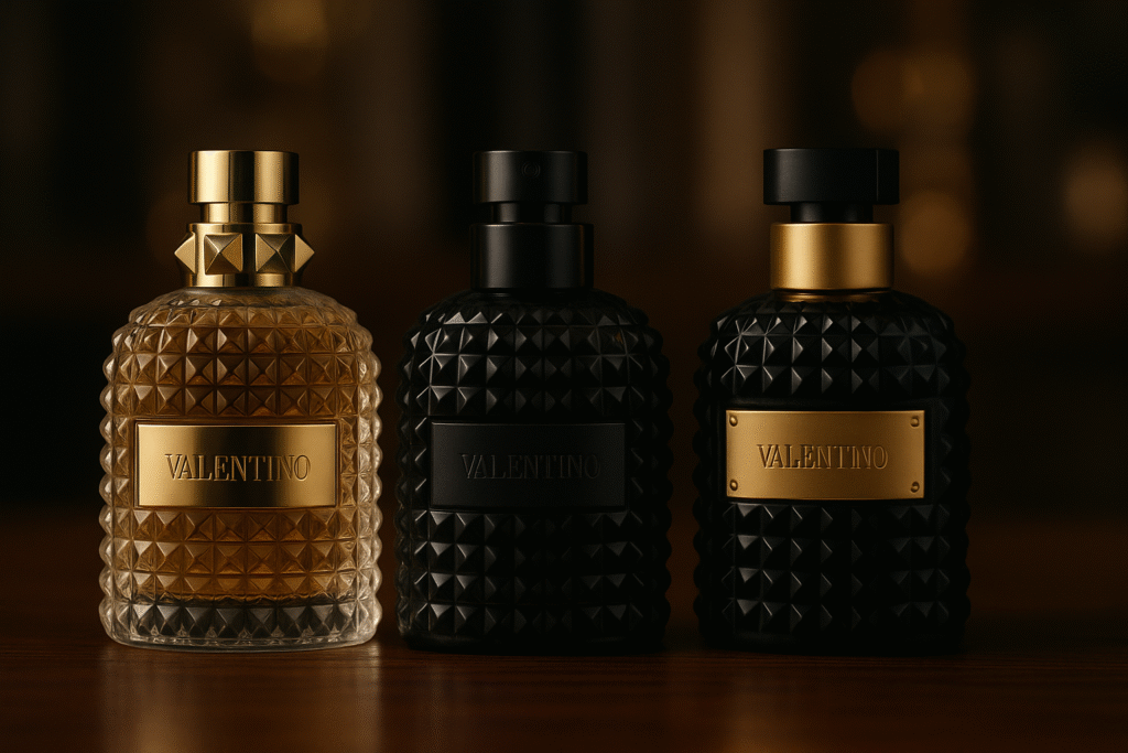 Close-up of Valentino Uomo, Uomo Intense, and Uomo Noir Absolu bottles on a dark walnut table.