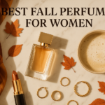 Flat lay of best fall perfumes for women with scarf, coffee, and autumn leaves.
