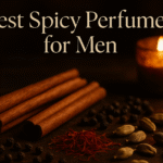 Cinnamon, saffron, pepper, and cardamom on a wooden table with candlelight, header image for best spicy perfumes for men.