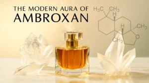 What is ambroxan in perfumery shown with a crystal bottle, marble surface, and glowing golden liquid in a modern editorial header style