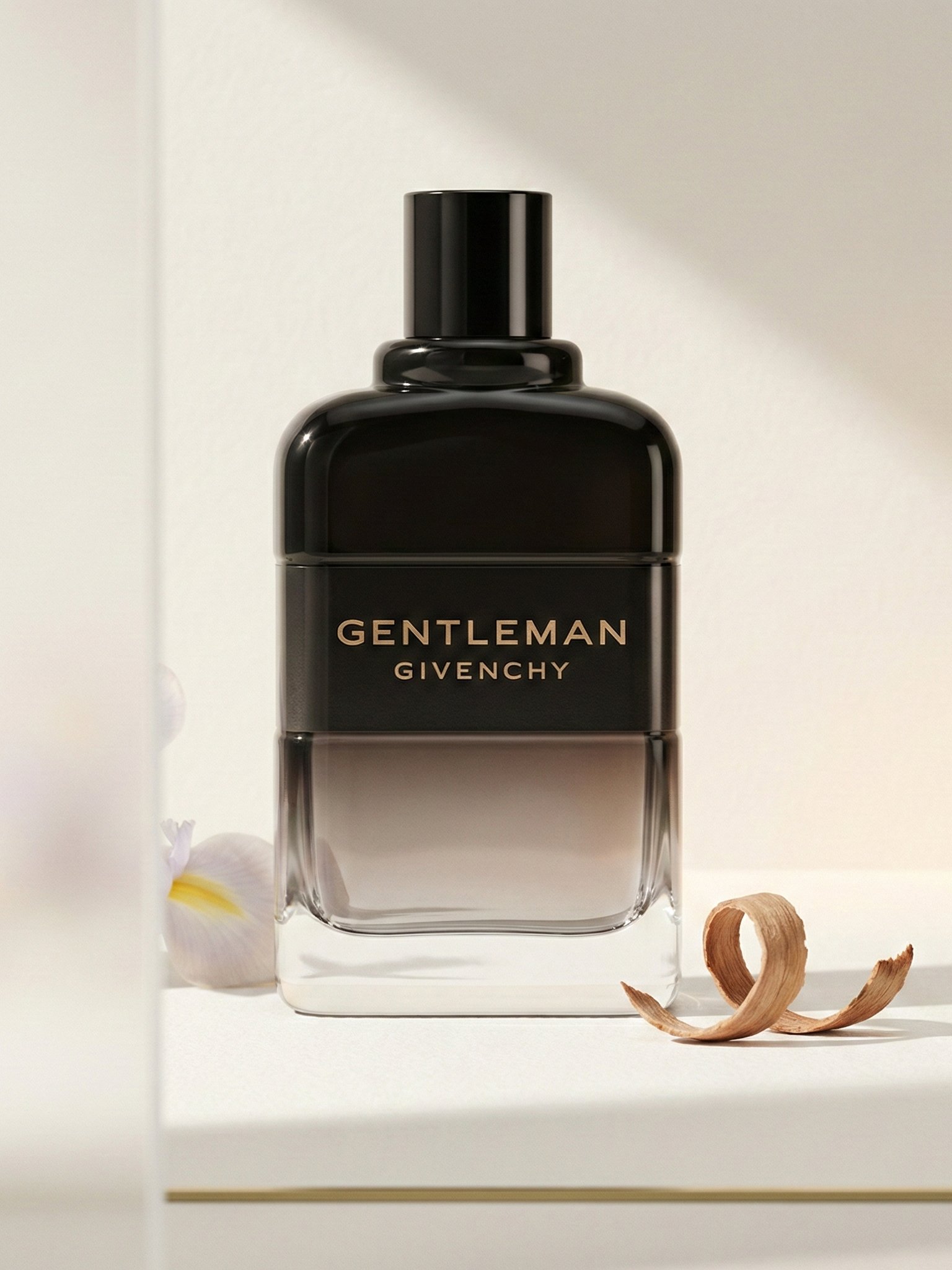 Givenchy Gentleman EDP Boisée bottle in a warm minimalist editorial scene