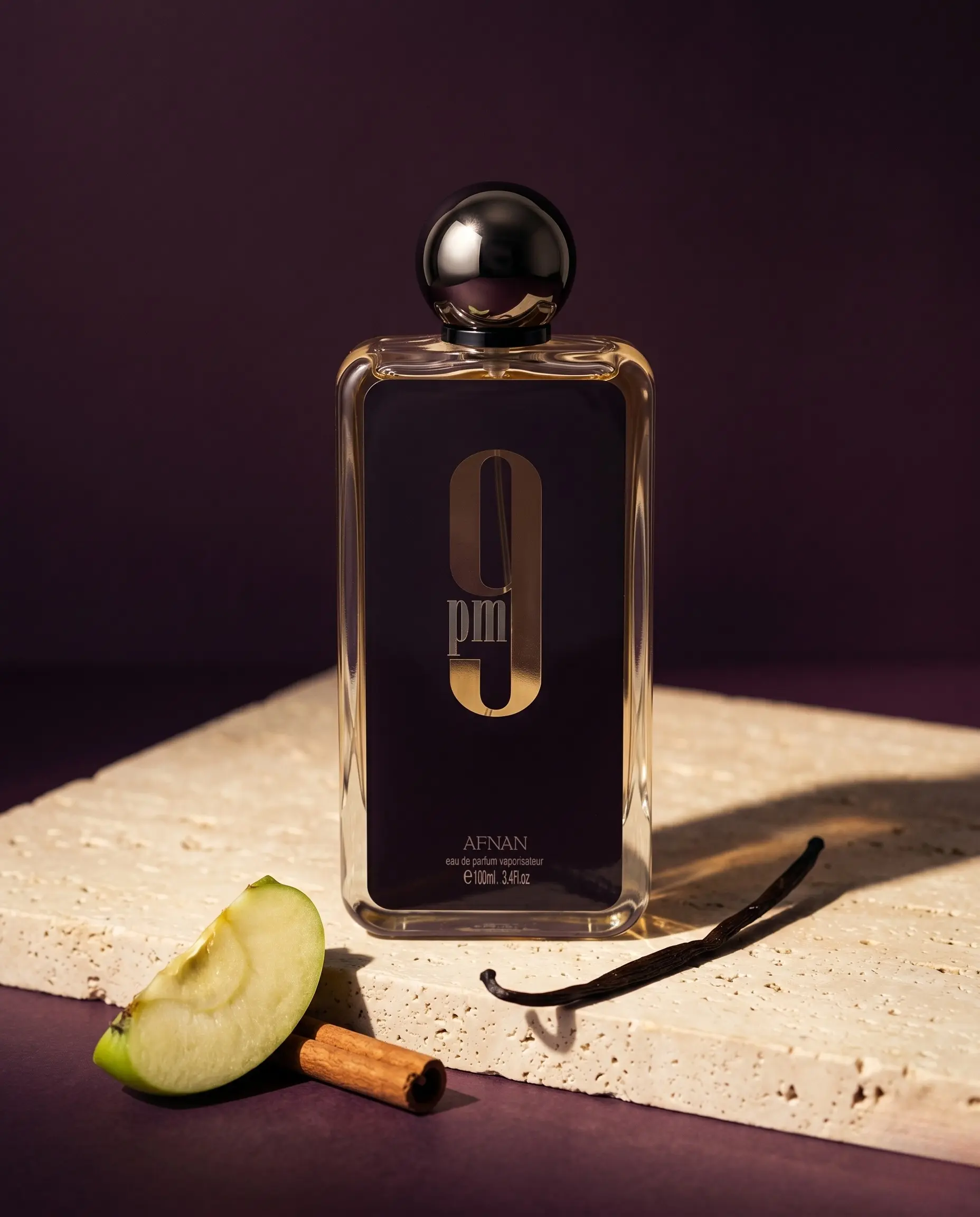 Afnan 9 PM bottle on travertine with apple and cinnamon